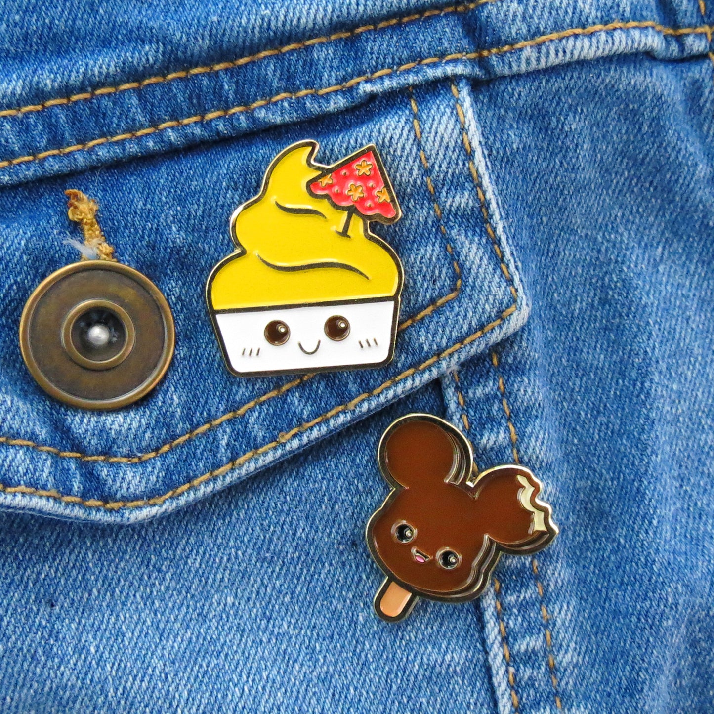Disney Dole Whip and Mickey Ice Cream enamel pins on jean jacket pocket