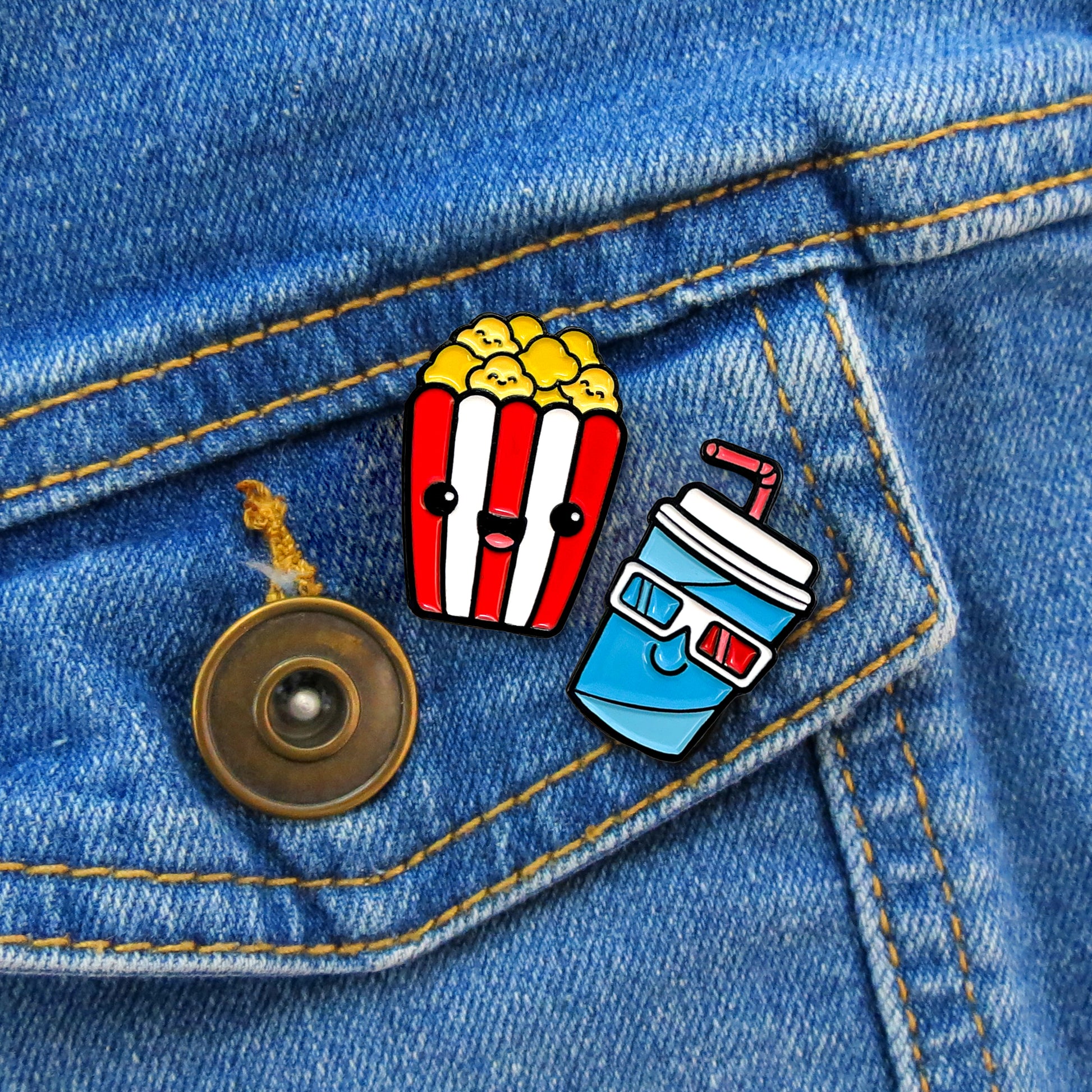 Popcorn and Soda enamel pins on jean jacket pocket