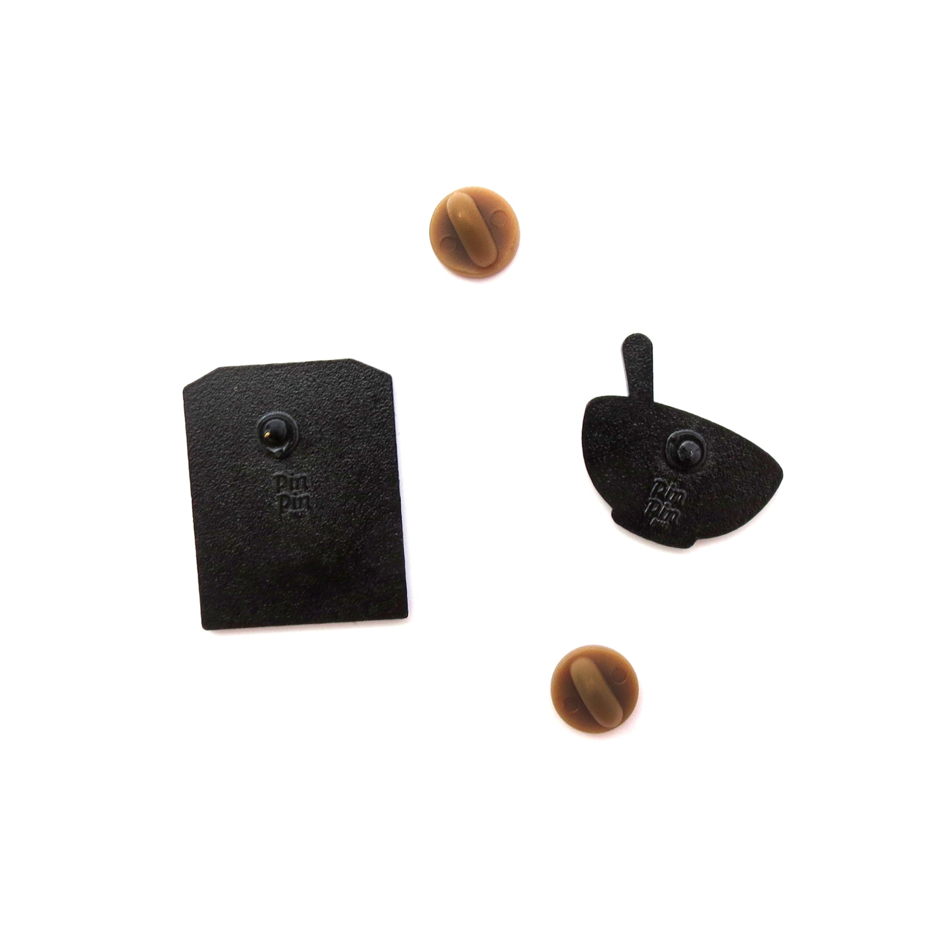 Backs of Cocoa Cereal Box and Cereal Bowl enamel pins with brown rubber backings