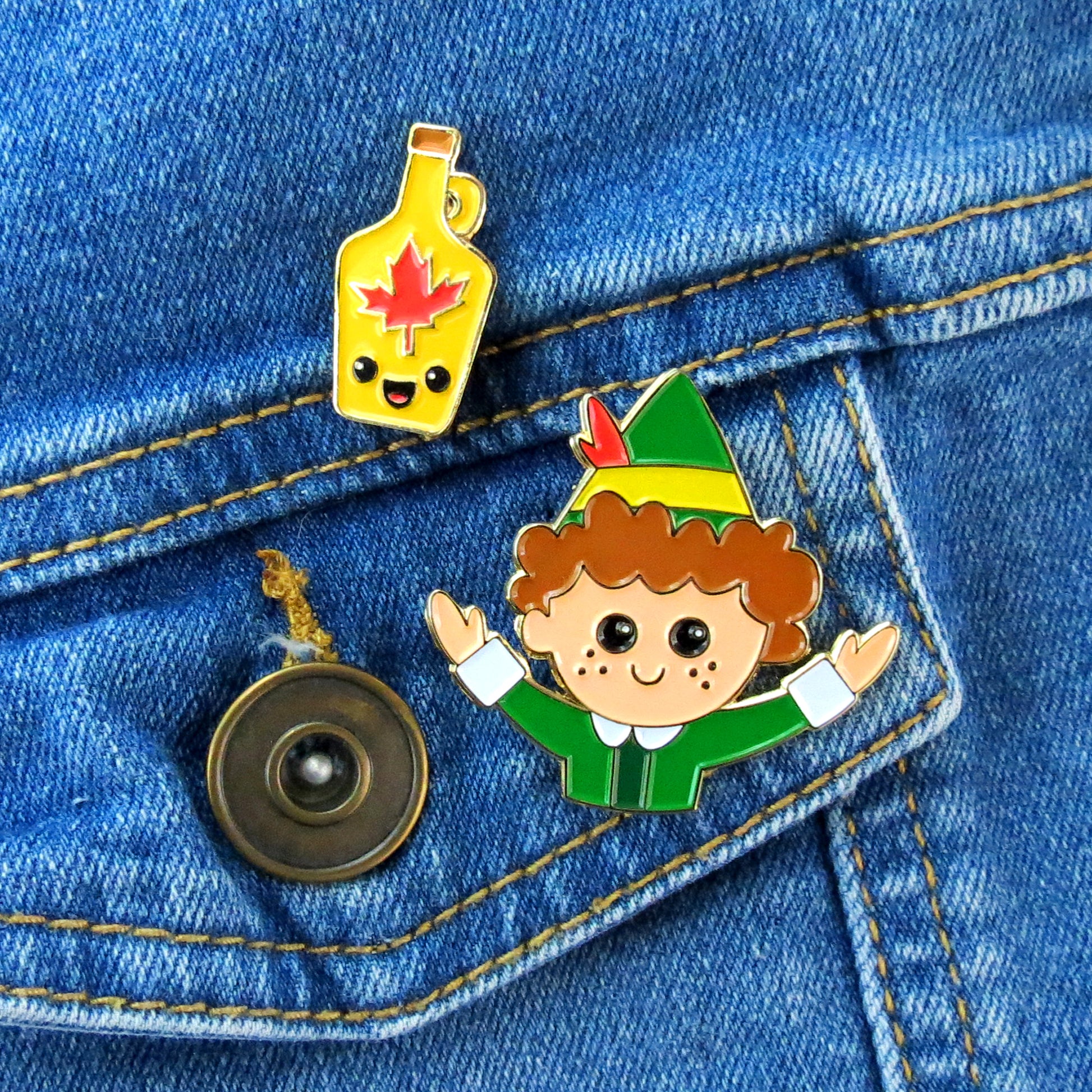 Buddy the Elf and Maple Syrup enamel pin set on jean jacket pocket