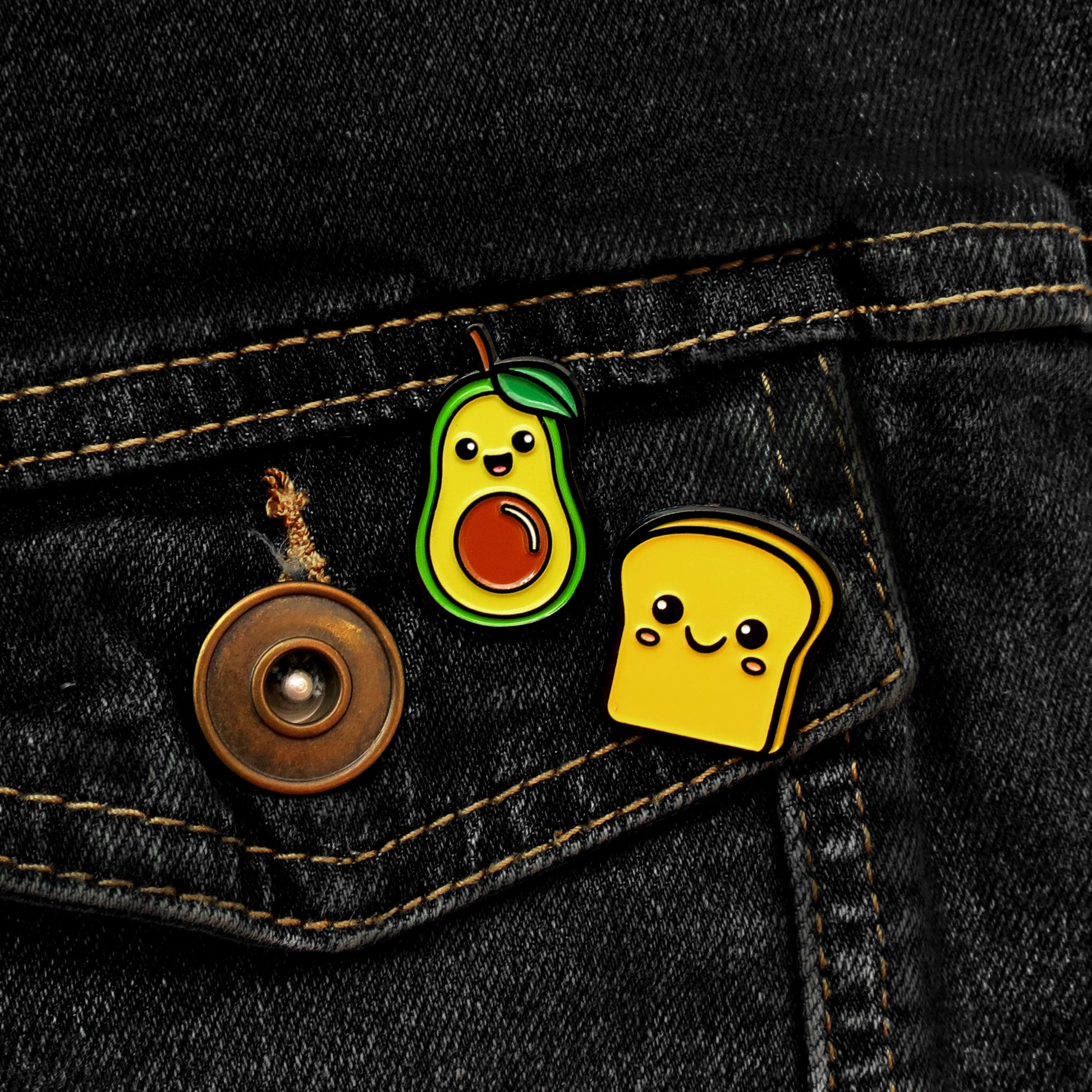 Avocado and Toast enamel pin set on black jean jacket pocket