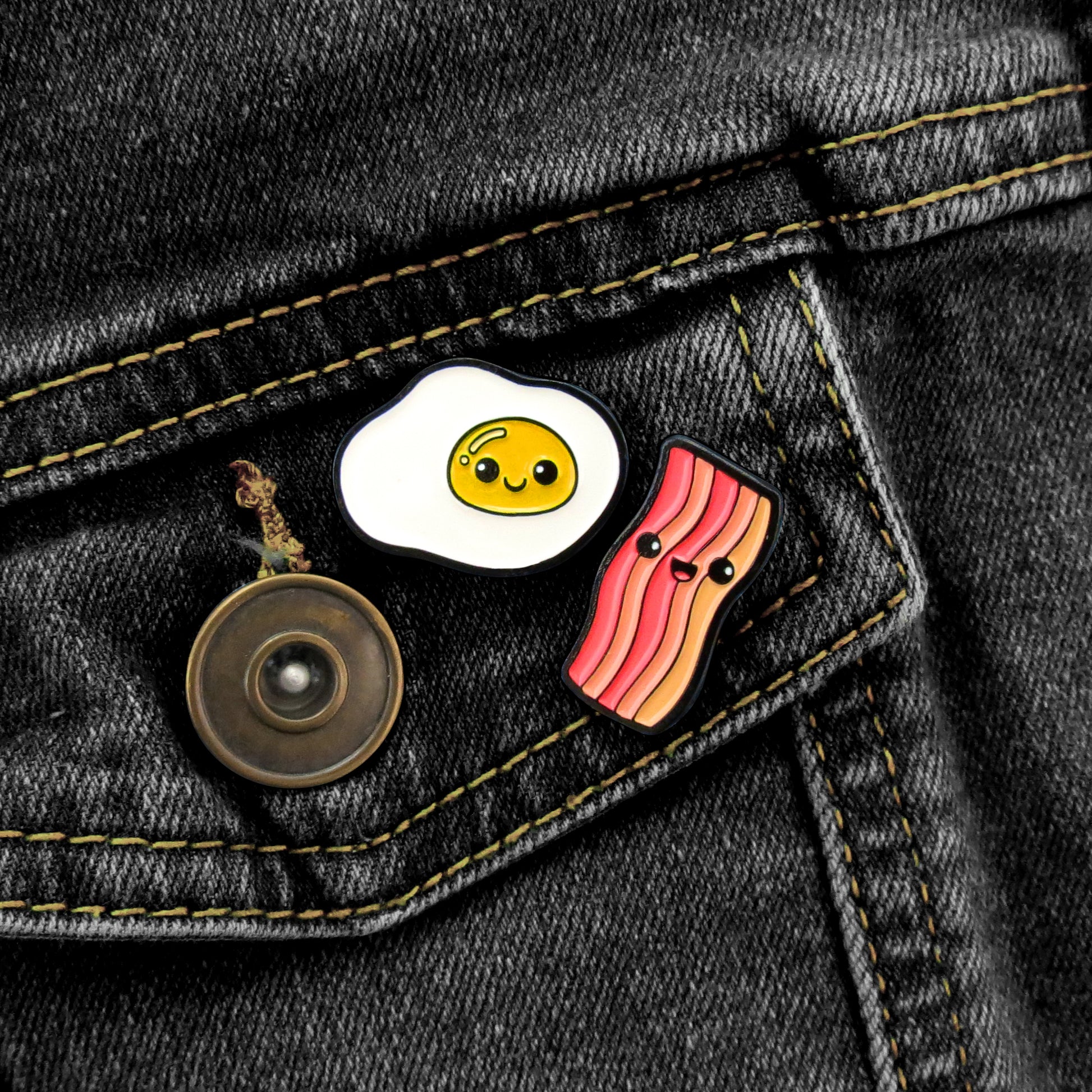 Pin Pin Pals Egg and Bacon enamel pin set on black jean jacket pocket