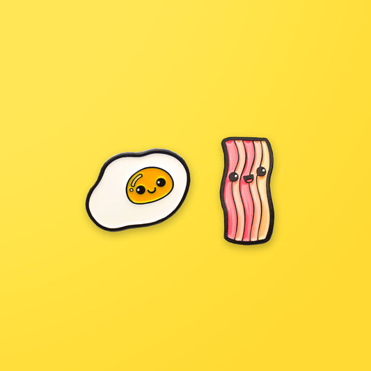 Pin Pin Pals Egg and Bacon enamel pin set on yellow background
