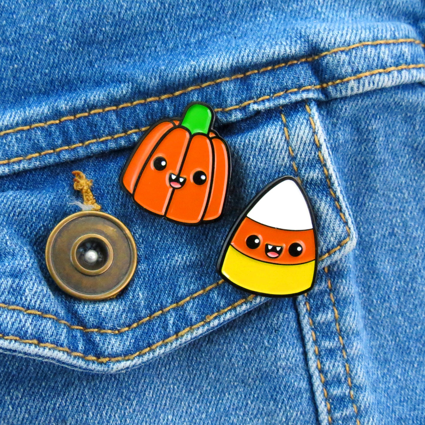 Halloween Pumpkin and Candy Corn enamel pin set on jean jacket pocket