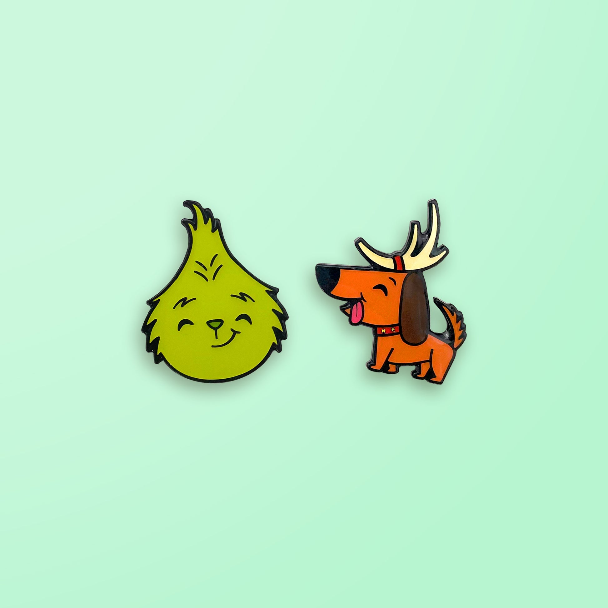 The Grinch and Max enamel pin set on mint green background