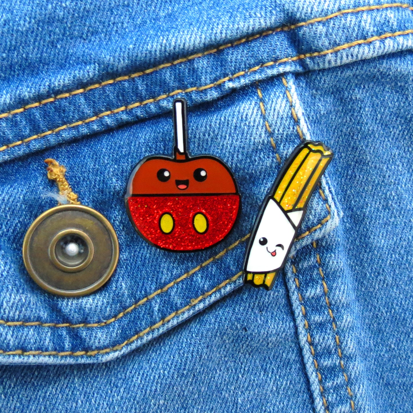 Caramel Apple and Churro enamel pin set on jean jacket pocket
