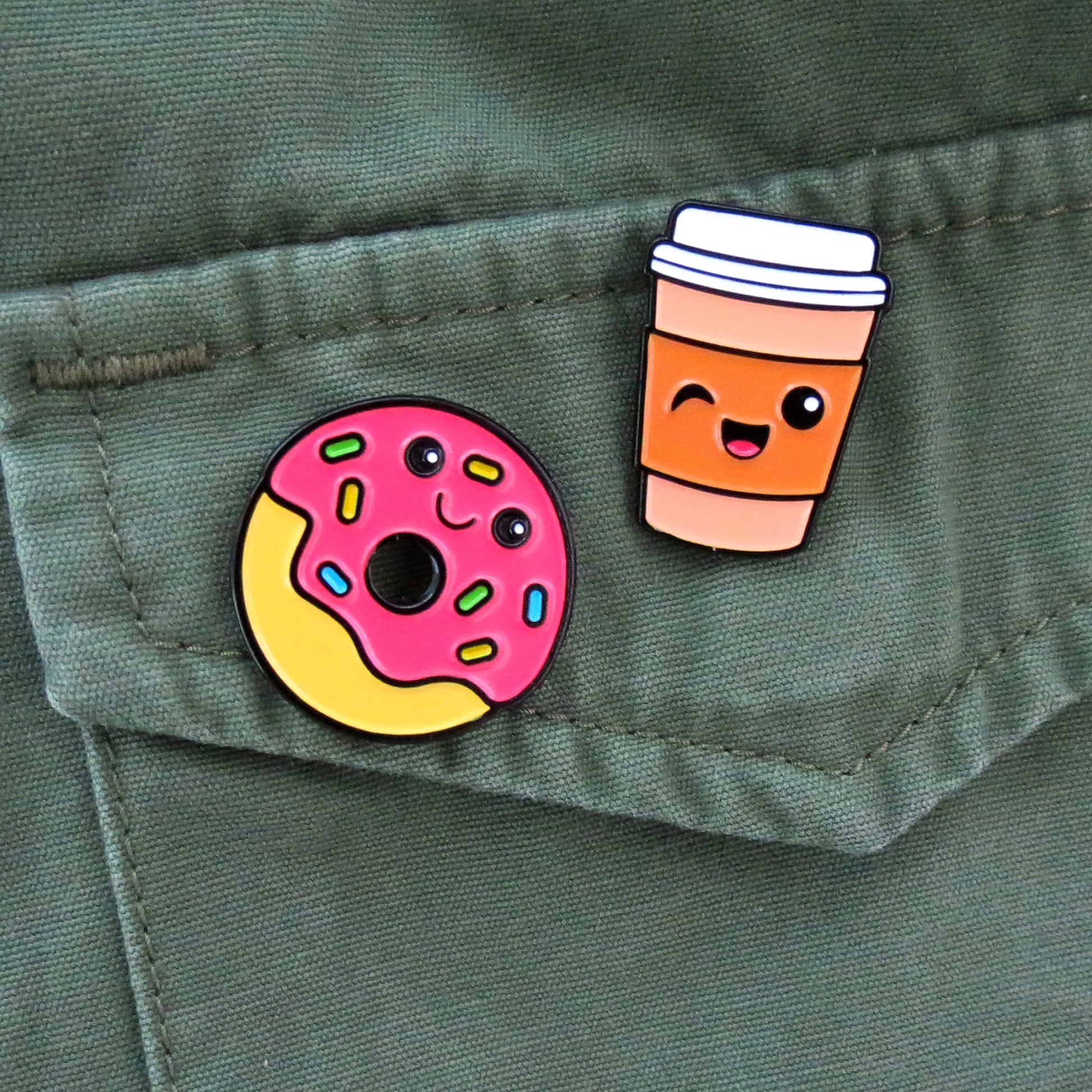 Donut and Coffee enamel pins on olive green canvas jacket pocket