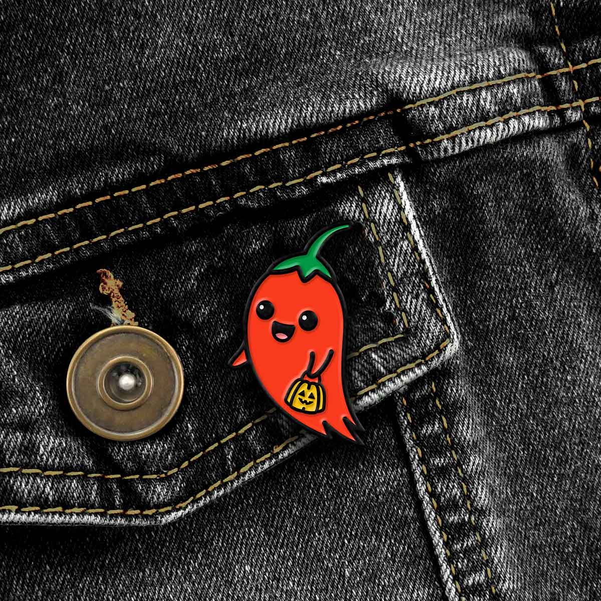 Ghost Pepper enamel pin on black jean jacket pocket