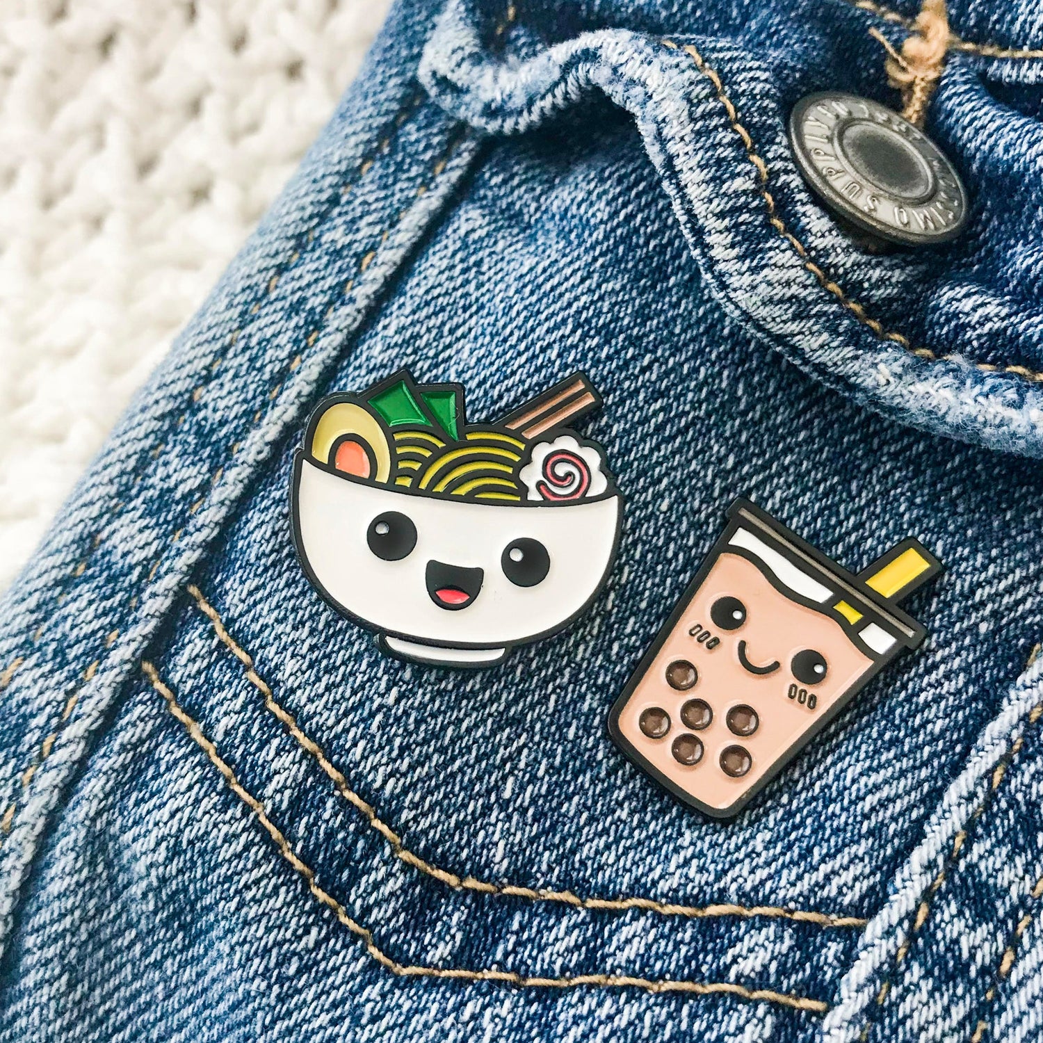 Ramen and Boba enamel pin set on jean jacket pocket