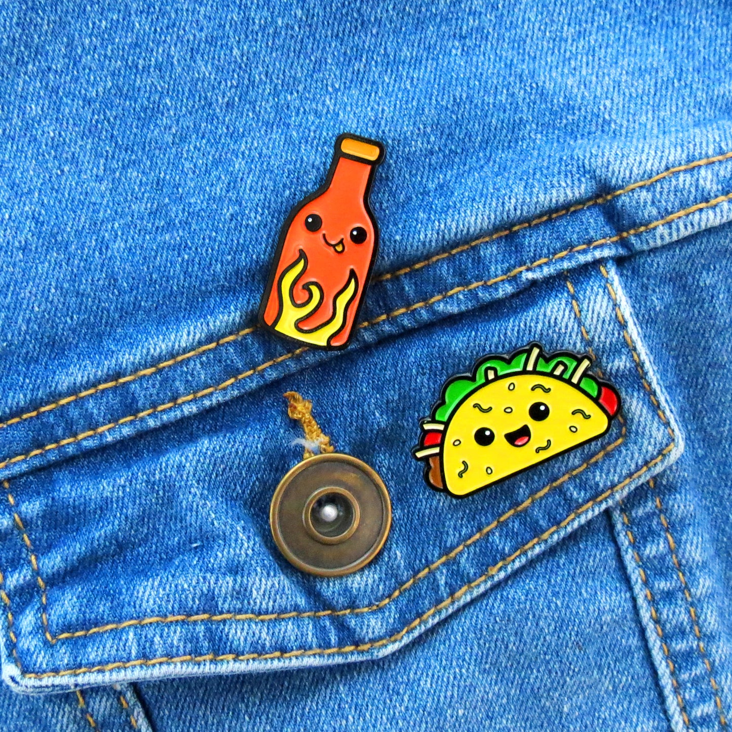 Taco and Hot Sauce enamel pins on jean jacket pocket