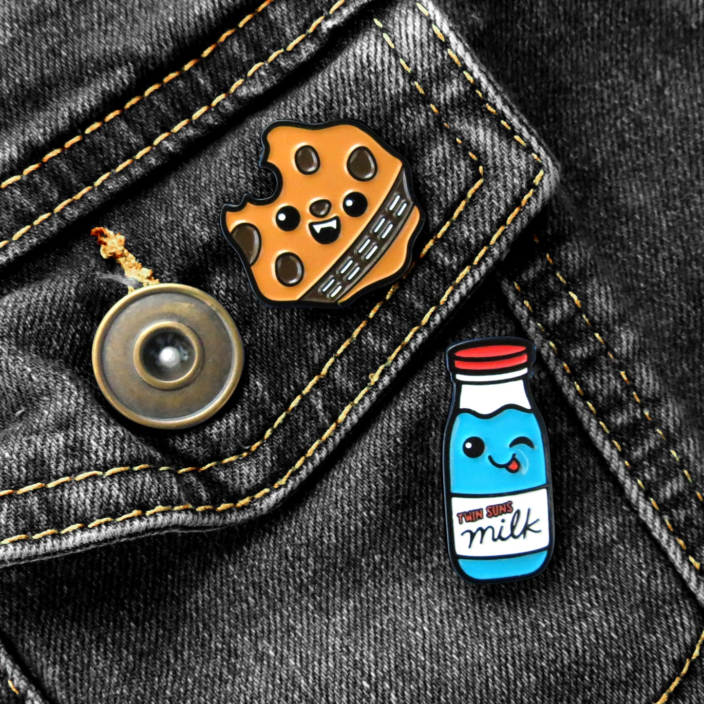 Star Wars Wookie Cookie and Blue Milk enamel pins on black jean jacket pocket