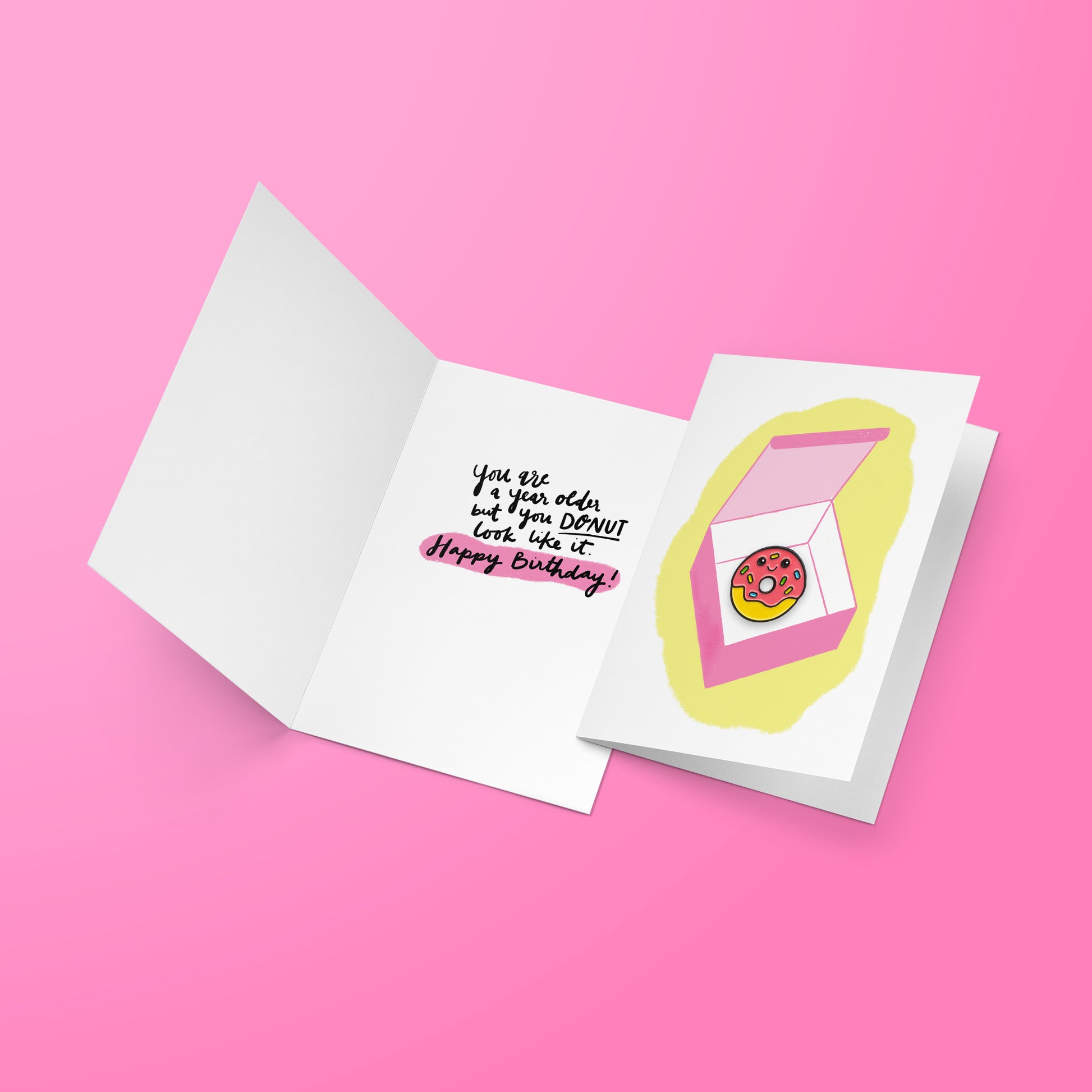 Happy Birthday Donut greeting card opened over pink background